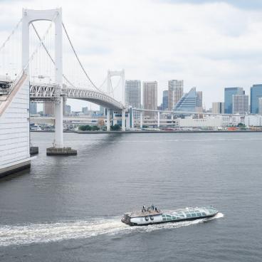 Pont Rainbow Bridge (Tokyo), vue depuis Odaiba avec la rivière Sumida et le bateau de croisière Hotaluna
